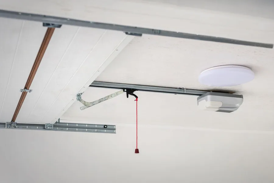 Garage door opener rail and motor installed on a garage ceiling
